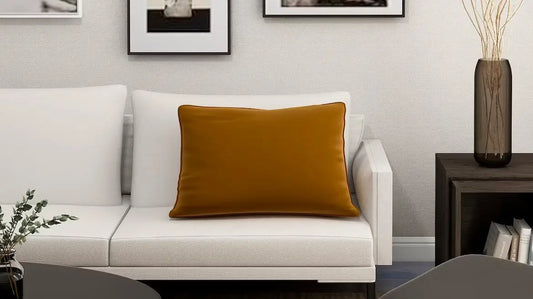 Mustard yellow throw pillow accentuating a white couch in modern interior design setting